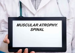 Muscular Atrophy.  Doctor with rare or orphan disease text on tablet screen Muscular Atrophy