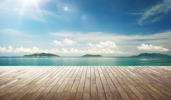 Empty wood jetty floor in front of beautiful afternoon seascape .