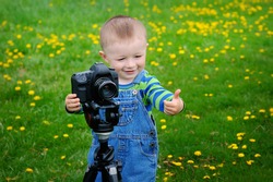 little boy on the camera shoots.