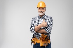 portrait of mature happy handyman showing thumb up, isolated on white background