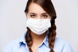 Girl wearing mask, female in face protective medical mask, white isolated background. highquality image