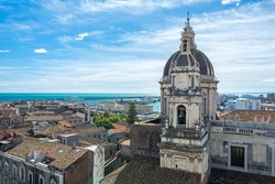 View over the cityscape of Catania on the island of Sicily in Italy with famous cathedral (Cattedrale di Sant'Agata) and harbour 