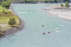 Rafters rafting down a mountain river. The picture was taken on the Katun river in the Altai mountains, in autumn