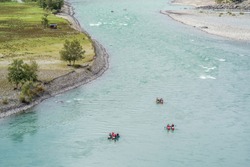 Rafters rafting down a mountain river. The picture was taken on the Katun river in the Altai mountains, in autumn