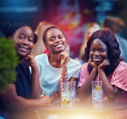 happy african american friends, students having fun, drinking cocktails on a summer party