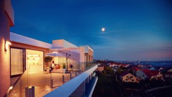 family relaxing on roof top patio with evening city view