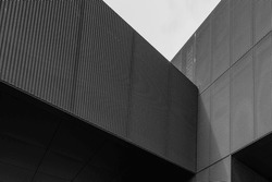Black and white tone, Exterior architectural detail of aluminium perforated cladding facade of modern buildings. Abstract Urban metropolis background.