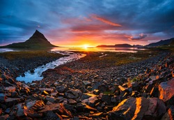 The picturesque sunset over landscapes and waterfalls. Kirkjufell mountain. Iceland