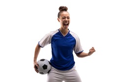 Biracial young female player shouting while standing with clenched fist and soccer ball. white background, unaltered, sport, sports uniform, copy space, victory, athlete and women's soccer.
