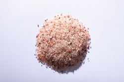 Directly above shot of pink himalayan rock salt on white background with copy space. unaltered, ingredient, food, rock salt and seasoning.