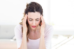 Woman having headache on white background