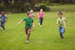 Cute pupils running towards camera on elementary school campus