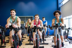 Fit people in a spin class the gym