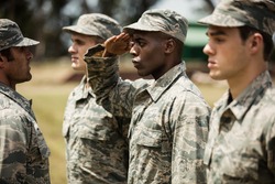 Military trainer giving training to military soldier at boot camp