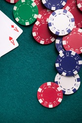 Colored poker chips on a table in casino. gambling concept background. vertical photo