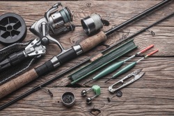 Fishing tackle for fishing peaceful fish. Float, fishing rod, reel, fishing line on the wooden background