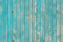 Wall of wooden planks of blue color with cracks. Background for design.