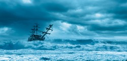 Sailing old ship in a storm sea on the background stormy clouds