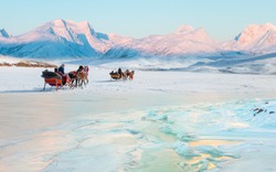 Cracking ice, frozen Cildir Lake coast at sunrise  Horses pulling sleigh in winter - Cildir Lake, Kars