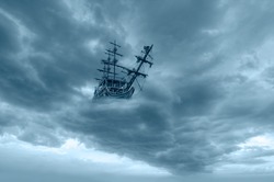 Flying old ship in the stormy dark clouds