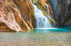 Deep forest Waterfall - Pebbles rocks underwater below Alara Ucansu waterfall with surface in shallow water - Antalya, Turkey