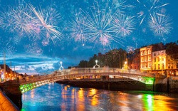 Ha'Penny Bridge at twilight blue hour with fireworks - Dublin, Ireland