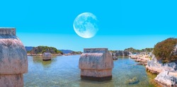 The ancient Lycian sarcophagus in water with full moon - Simena village, Kekova, Turkey