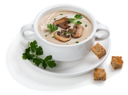 Mushroom cream soup decorated with sliced champignons, parsley and croutons in a white ceramic bowl. Isolated on white background 