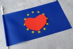 Flag of Europe with red heart symbol, european union flag on gray background, Europe Day 5th and 9th of May, Schumann Declaration day, I love Europe concept