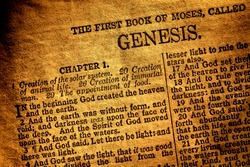 Old antique Holy Bible Christian religion book open to the first page of Moses original chapter of genesis and text about god creation of heaven and hearth in the religious Ancient Testament