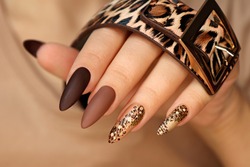 Luxurious multicolored manicure with animal design on long nails.