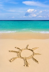 Drawing sun on beach - vacation concept background