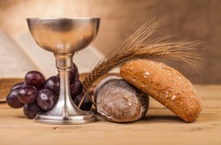 holy communion chalice on wooden table