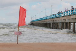 Warning sign of a red flag at a beautiful beach with a blue sky Baltic sea, Swimming are forbidden. Palanga, Lithuania, Europe - Dangerous zone. Swim is forbidden.