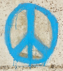 Simple graffity on a concrete wall, a peace sign