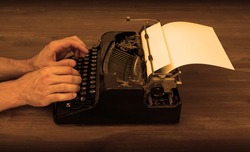Writer or reporter behind the typewriter in retrostyle