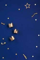 Traditional Three King's Day of January 6. Three gold crowns on blue background. Concept for Dia de Reyes Magos day, three Wise Men. Happy Epiphany day. Top view, copy space, flat lay.
