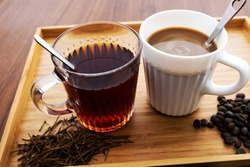 Hot coffee and tea on a wooden table