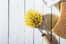 cleaning brush, sponge on white wooden table background