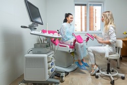 Photo of a gynecologist doctor and a patient on a gynecological chair. Preventive reception, preparation for medical examination, pregnancy management, health care gynecology contol