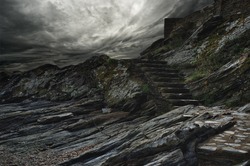 Dramatic sky over steps in a mountain.