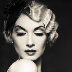 Monochrome portrait of elegant blond retro woman   with beautiful hairdo and little hat