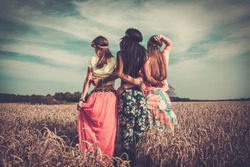 Multi-ethnic hippie girls  in a wheat field 
