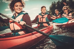 Group of happy people on a kayaks