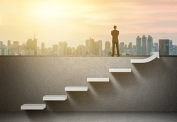 businessman stand on rising arrow graph on staircase with city sunrise background