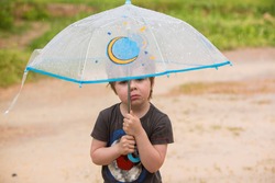 Little boy under umbrella