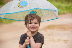 Little boy under umbrella