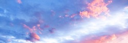 A delicate heavenly cloudscape sky with pink and white coloured cumulus cloud formation in a pastel blue sky. Sunset background image, Beauty in nature. New South Wales, Australia.