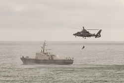 Special operations forces training. Military helicopter over ship.