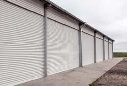 Storage units with roller shutter doors in industrial area